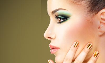 woman with stylish green makeup and gold nails showcasing elegant beauty trends for 20s