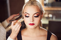 woman having makeup applied