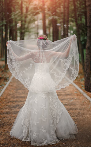 Bride standing in a forest