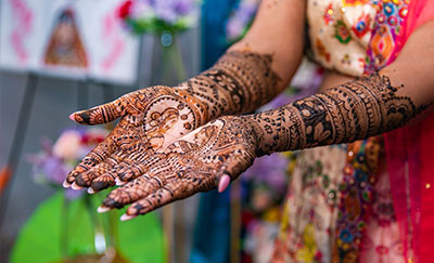 hands adorned with intricate henna designs