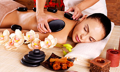 A woman getting a hot stone massage