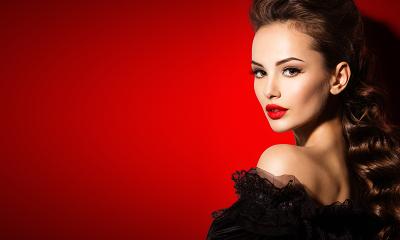 portrait of a beautiful woman with dark hair and red lips against a red background